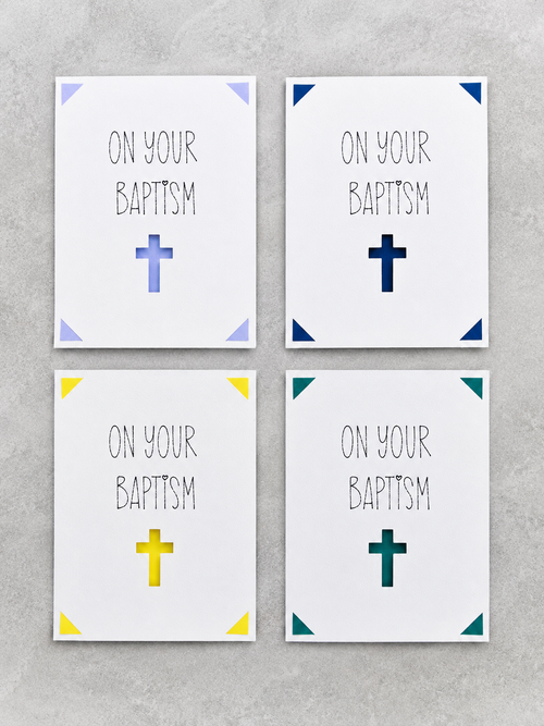 Four square wall art prints arranged in a 2x2 grid on a light gray textured background. Each print has the words 'ON YOUR BAPTISM' in black lettering above a simple cross, with different accent colors in the corners: light blue, dark blue, yellow, and teal.