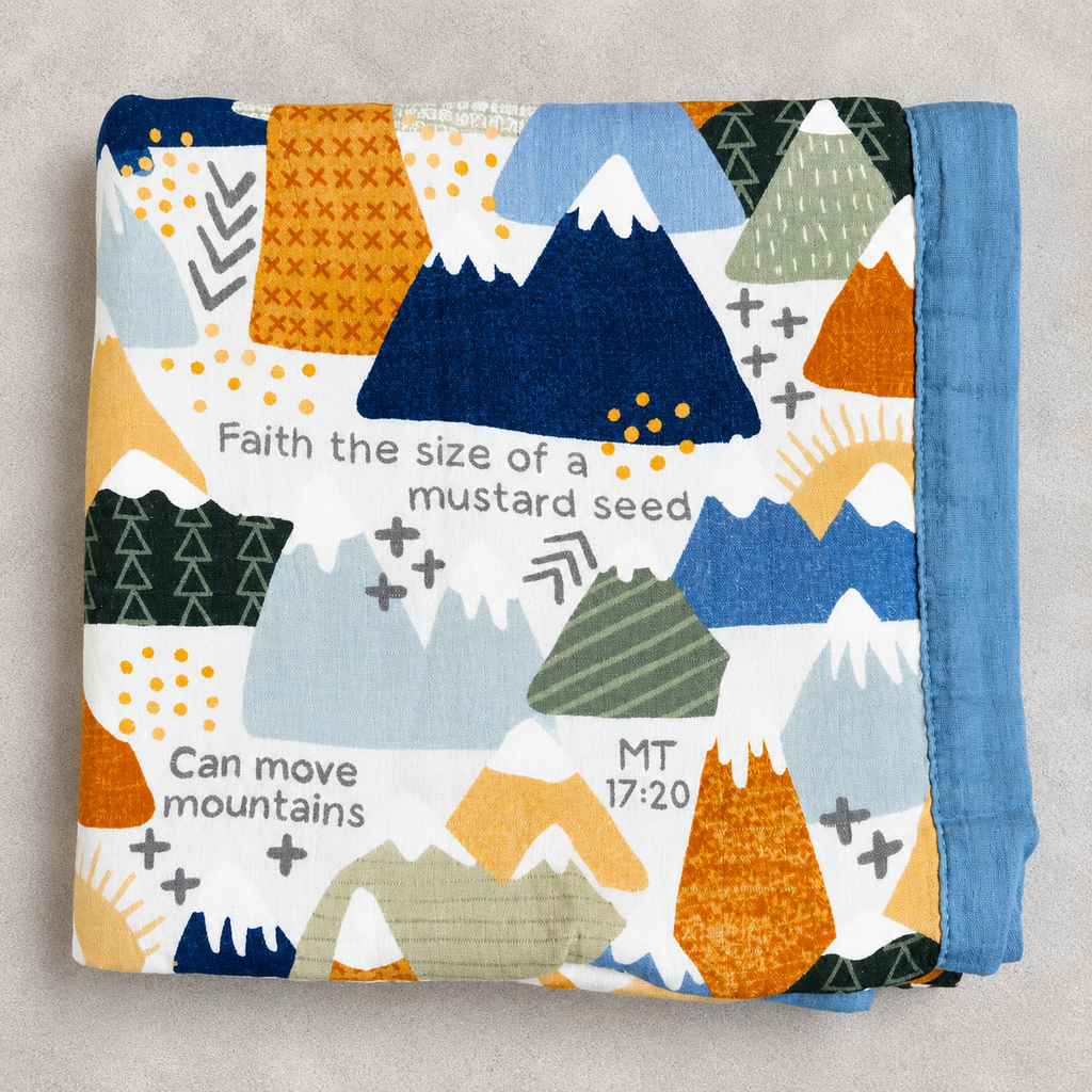 A folded baby blanket with a colorful geometric mountain pattern and Bible verse text, displayed on a neutral gray background.