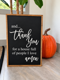 A framed black chalkboard sign with white script text reading 'and.