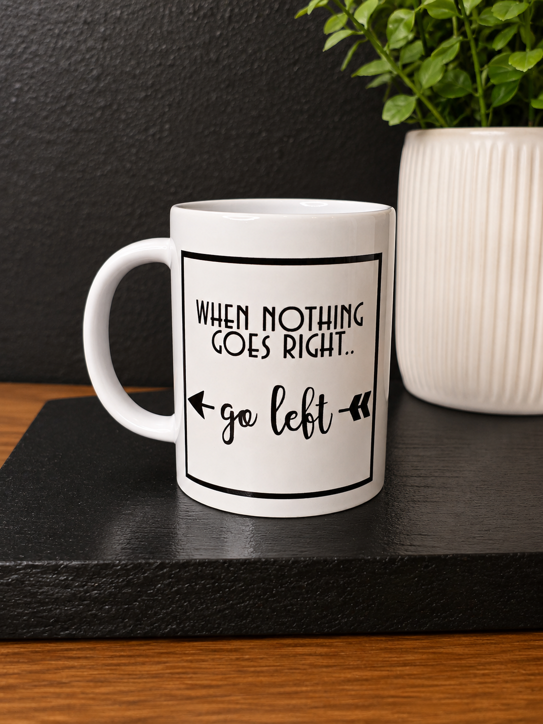 A white ceramic mug with a black printed graphic that reads 'WHEN NOTHING GOES RIGHT.